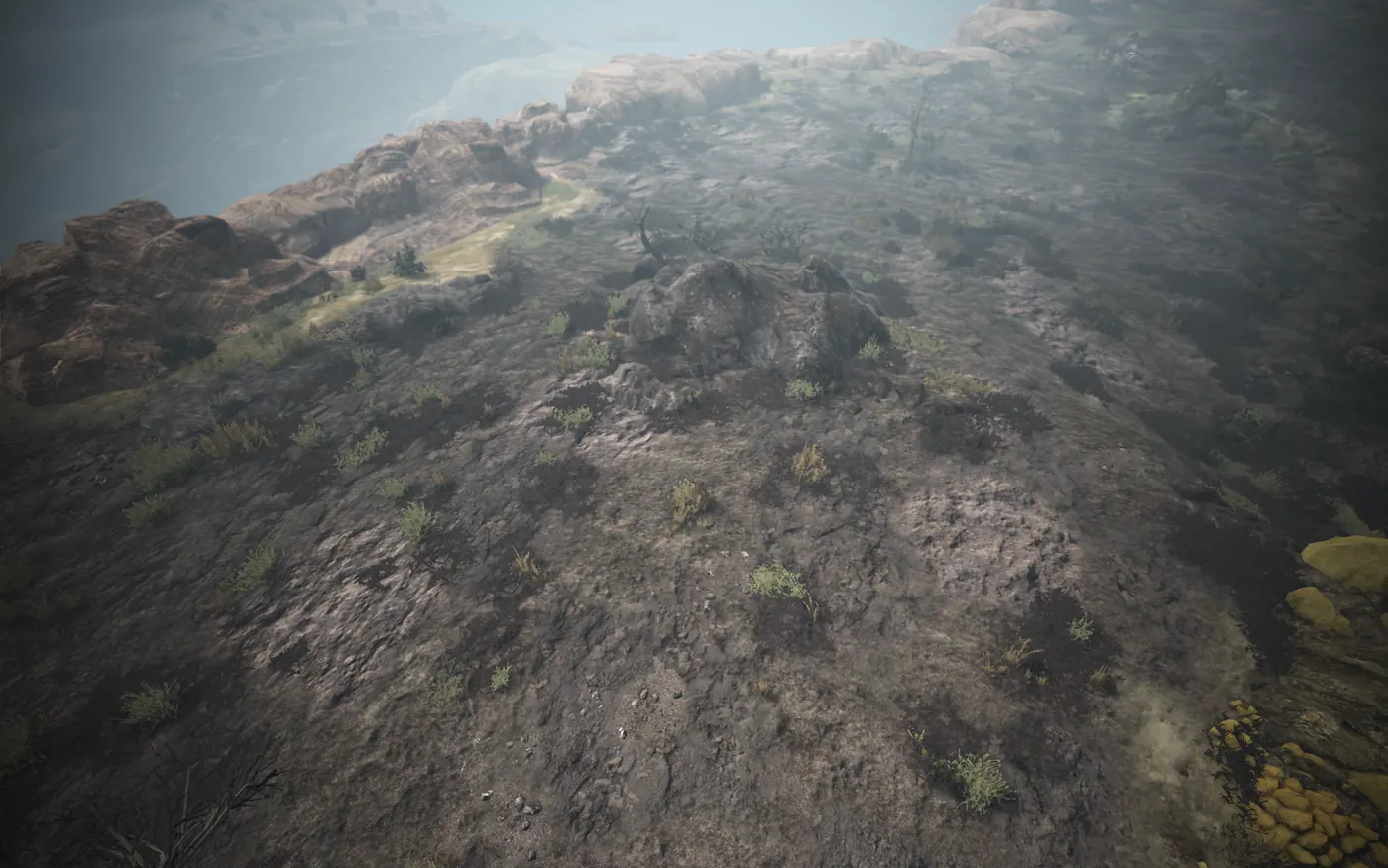 A grey rocky clifftop plateau with sparse grass above the sea